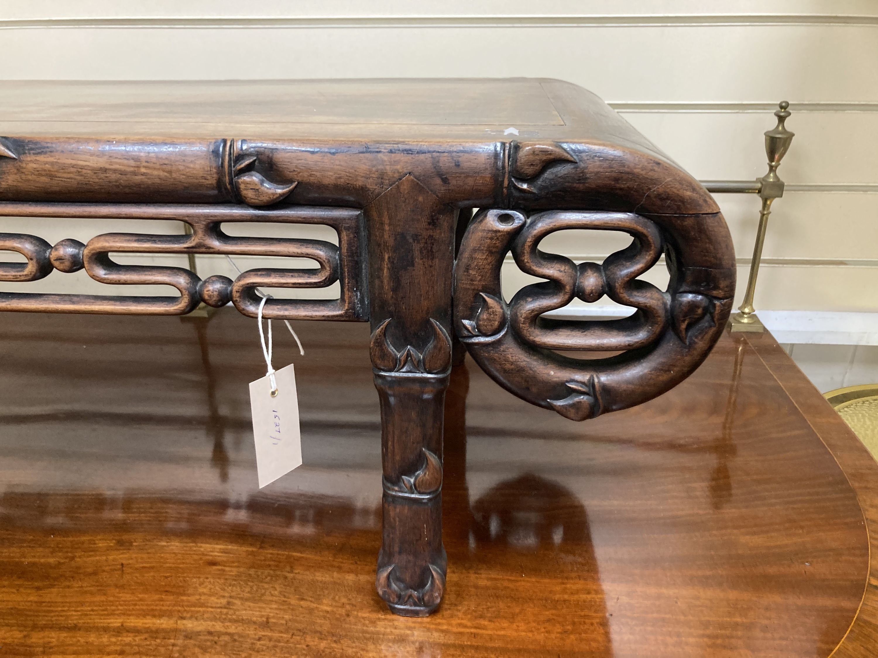 A Chinese carved hardwood low occasional table. W-110, D-44, H-32cm.